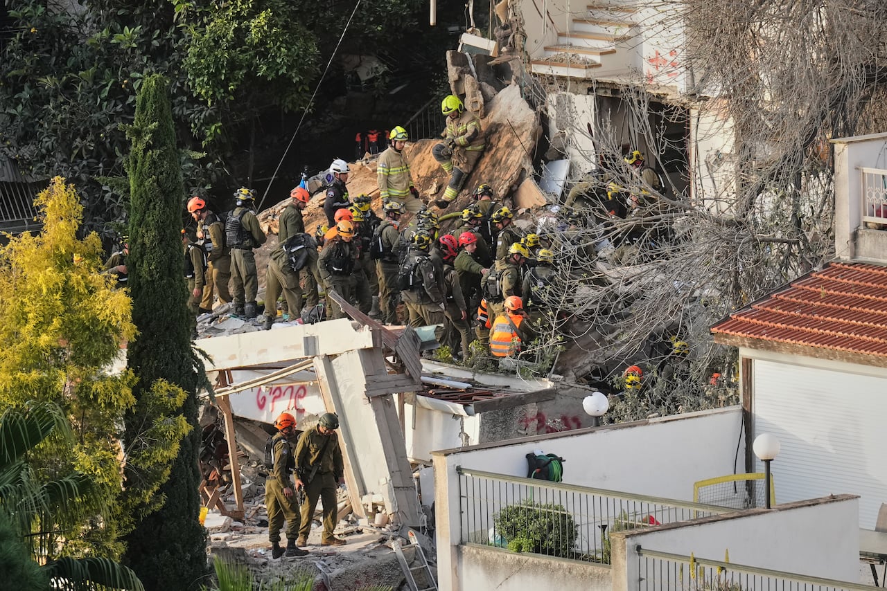 rescue workers search rubble