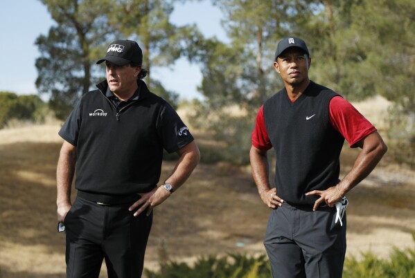 Phil Mickelson, left, and Tiger Woods stand at the first tee before a golf match at Shadow Creek golf course, Nov. 23, 2018, in Las Vegas. (AP Photo/John Locher, File)
