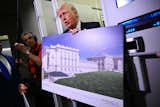 Trump shares a plan of the new East Wing plan with reporters aboard Air Force One in March of 2026.