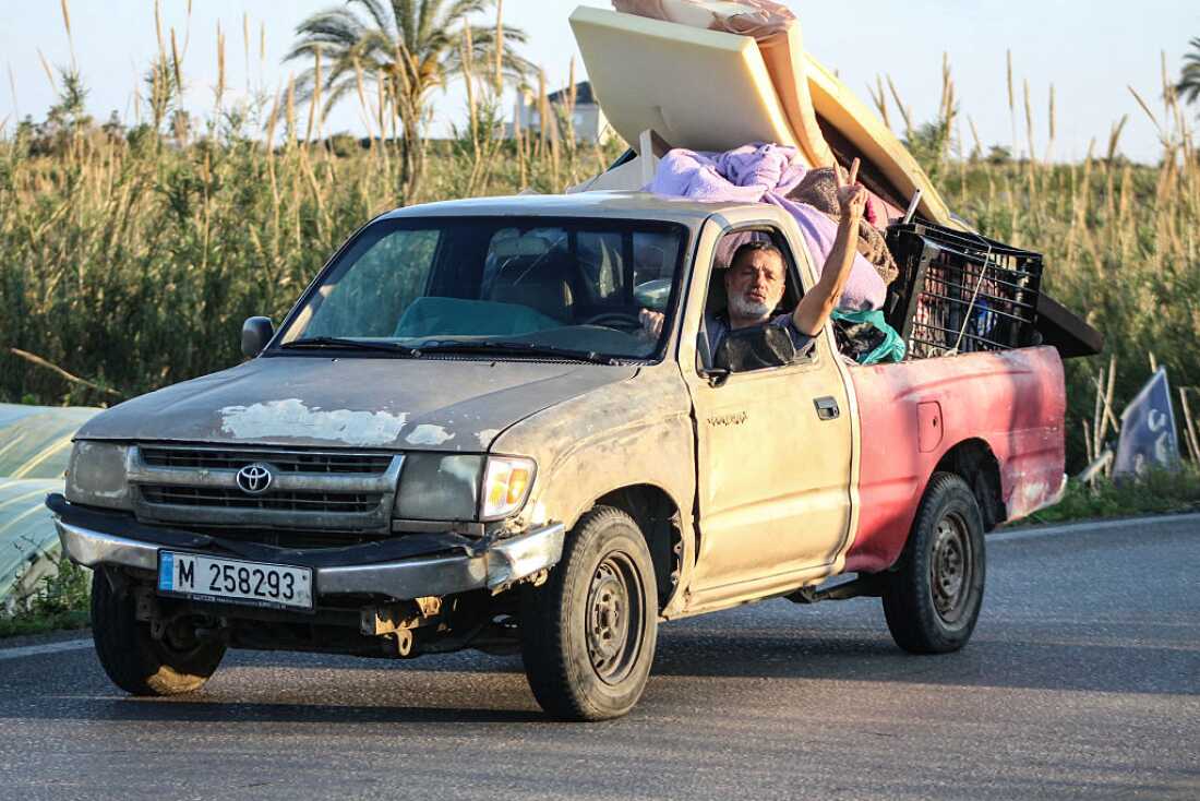 A man flashes the V-sign while driving a vehicle loaded with belongings through the al-Qassimyah area en route to southern Lebanon early on Wednesday, after the U.S. and Iran agreed to a two-week ceasefire. Israel continued its strikes in Lebanon saying it was not part of the truce.