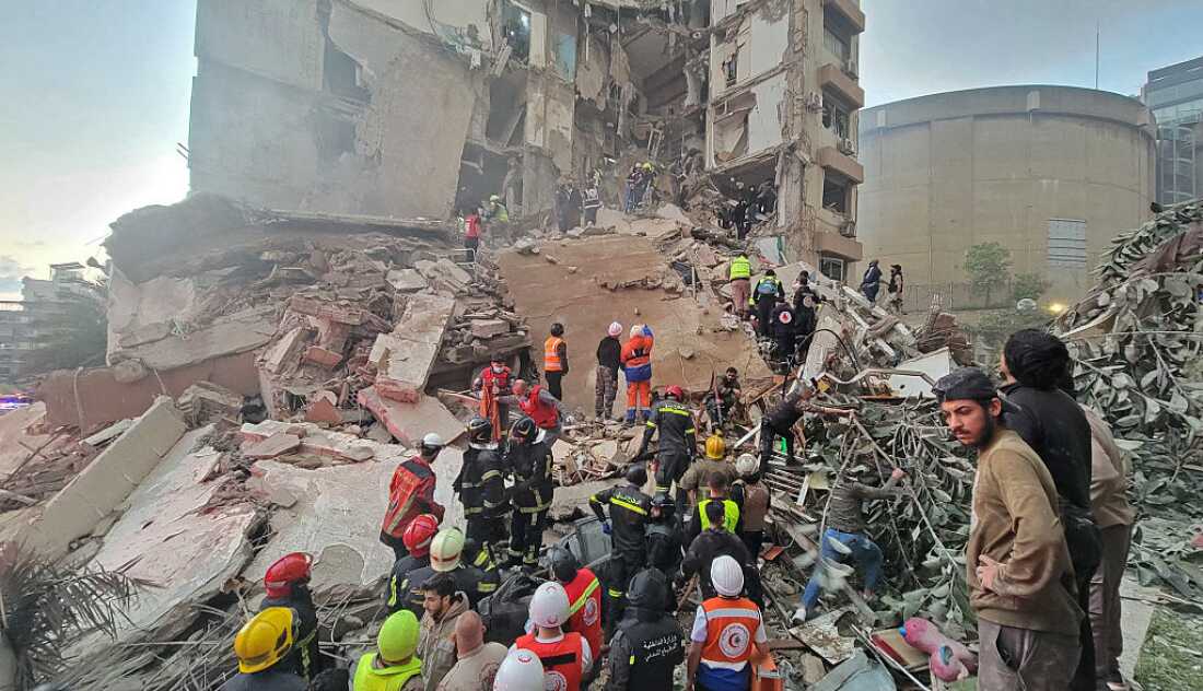 First responders and residents gather at the site of an Israeli airstrike in Beirut's Tallet al-Khayyat neighbourhood, on April 8, 2026.