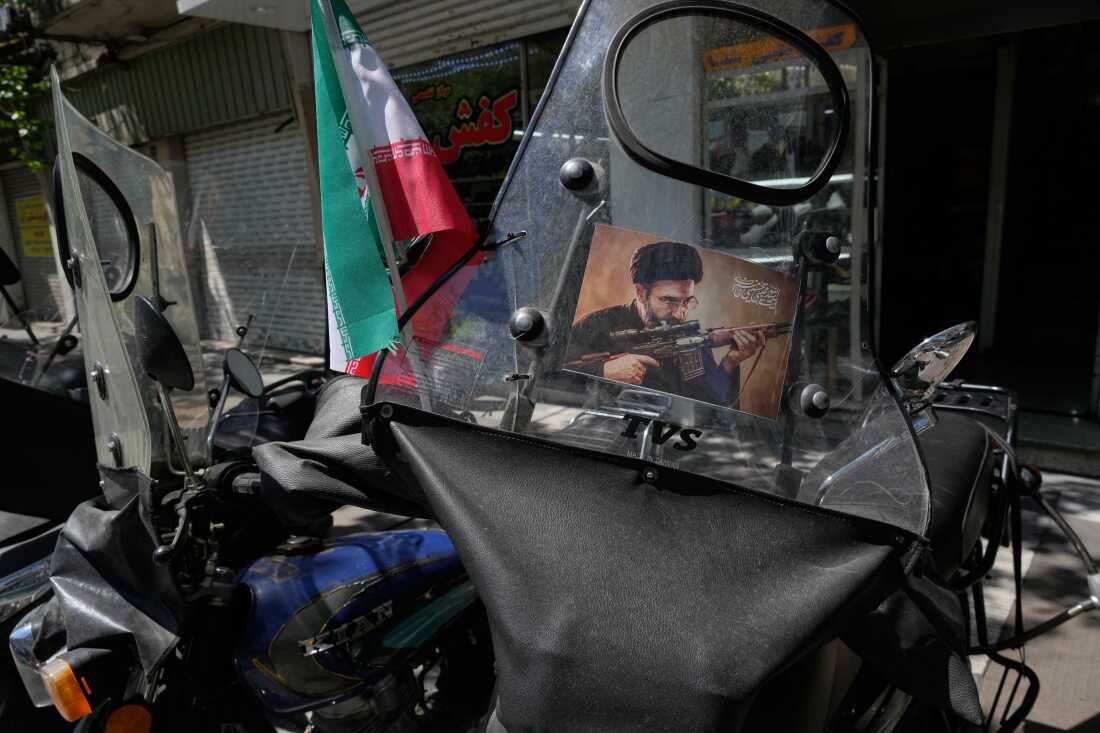 A poster is pasted on a motorbike windshield with graphic depicting Iran's Supreme Leader Ayatollah Mojtaba Khamenei as government supporters gather to mark the 40th day since the killing of his father, Supreme Leader Ayatollah Ali Khamenei, in Tehran, Iran, Thursday, April 9, 2026.