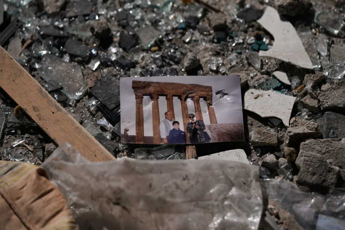 A family picture sits in the rubble at the site of a destroyed building that was hit a day ahead in an Israeli airstrike in central Beirut, Lebanon, Thursday, April 9, 2026.
