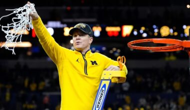 Michigan head coach Dusty May swings the net after winning the NCAA national championship against Connecticut at Lucas Oil Stadium in Indianapolis on Monday, April 6, 2026.