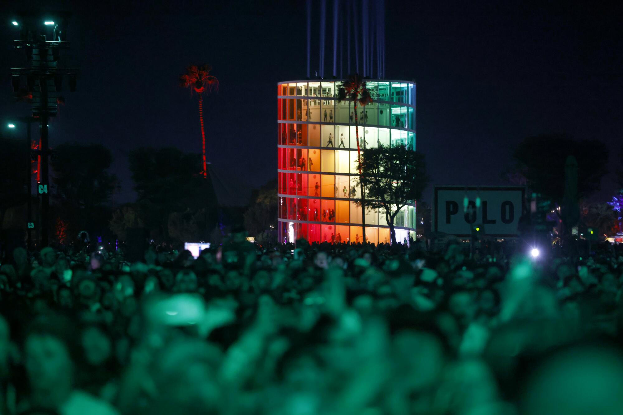 People watch The Strokes perform in front of the "Spectra" installation.