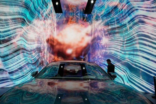 A man looks at the electric Han EV sedan from Chinese automaker BYD during the Auto Shanghai 2023 show in Shanghai, on April 19, 2023. (AP Photo/Ng Han Guan, File)