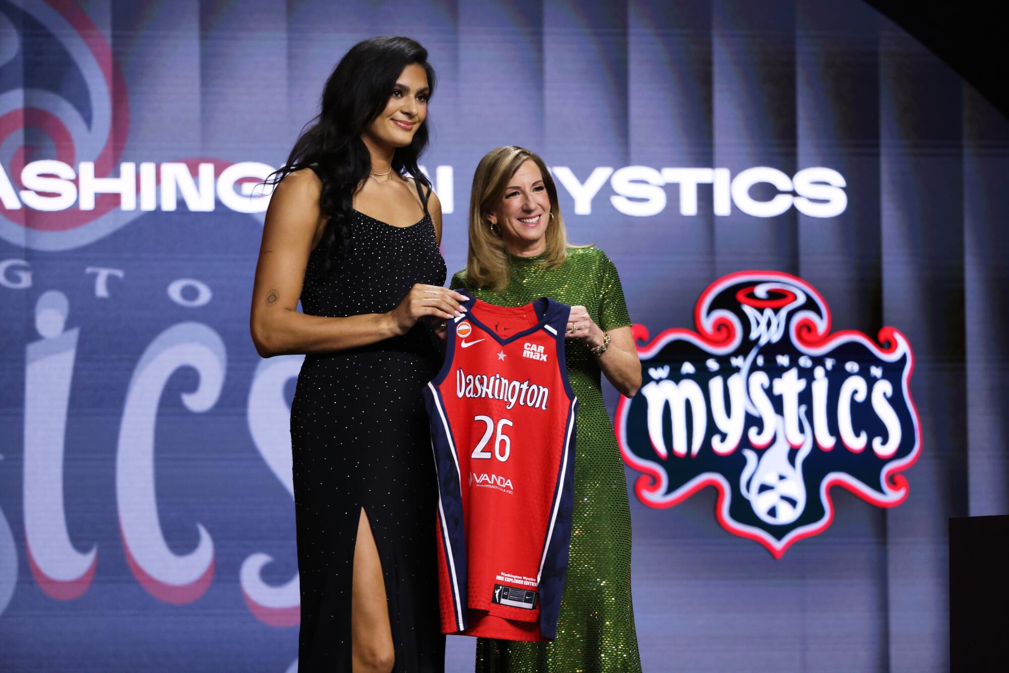 UCLA center Lauren Betts poses with WNBA commissioner Cathy Engelbert after being selected No. 4 by the Mystics.