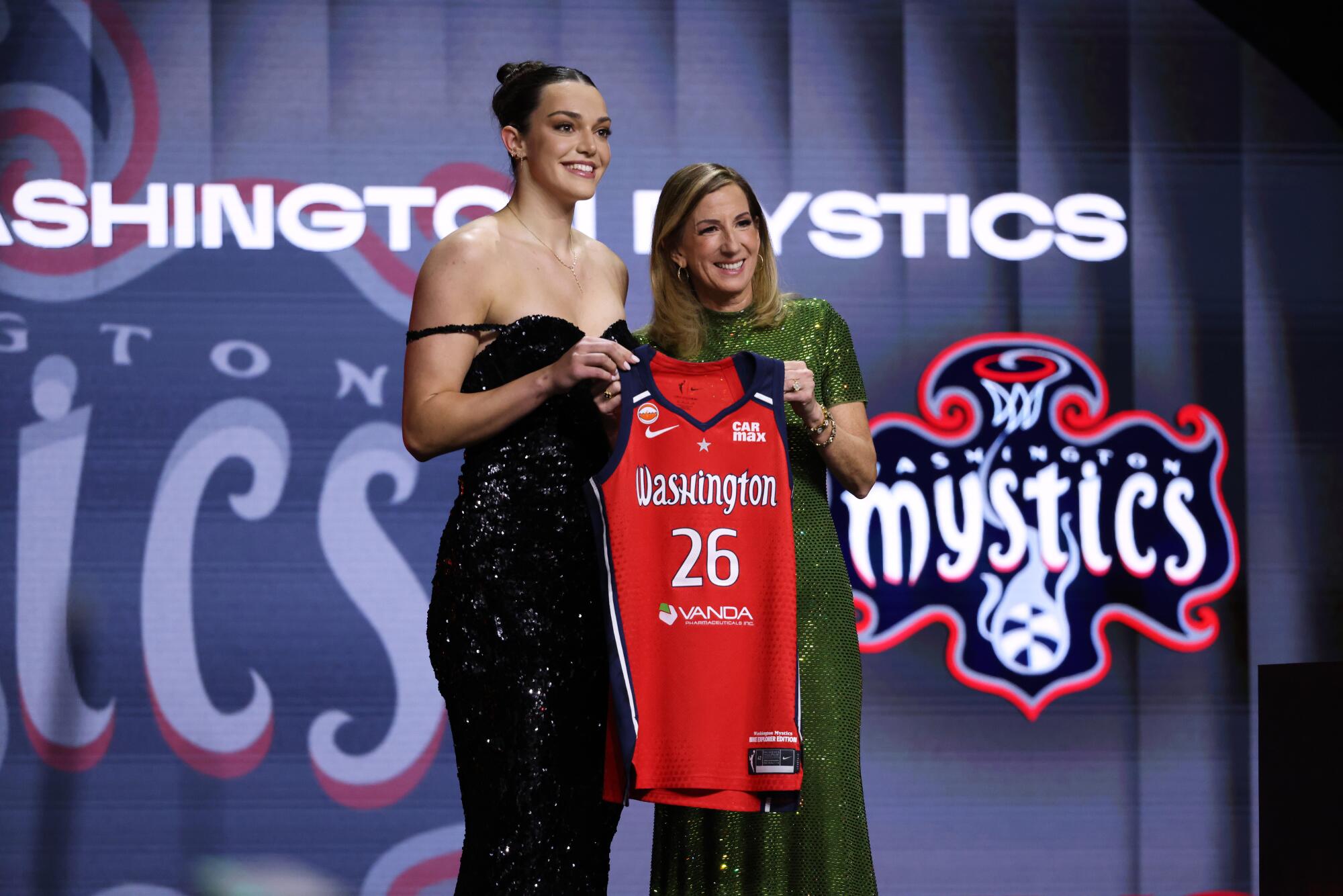 UCLA forward Angela Dugalic poses with WNBA commissioner Cathy Engelbert after being drafted No. 9 by the Mystics.