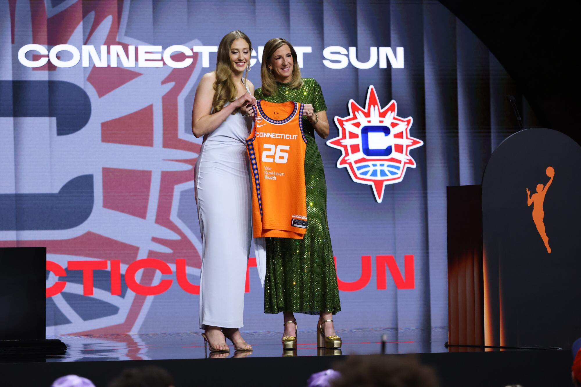 UCLA guard Gianna Kneepkens poses with WNBA commissioner Cathy Engelbert after being selected No. 15.