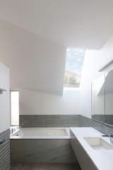 To maintain privacy from neighbors on either side of the home while still bringing in light, La Dallman inserted skylights, as in the primary bath.