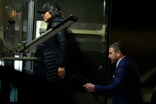 Director of National Intelligence Tulsi Gabbard, left, and FBI Deputy Director Andrew Bailey, enter a command vehicle as the FBI takes Fulton County 2020 Election ballots, Wednesday, Jan. 28, 2026, in Union City, Ga., near Atlanta. (AP Photo/Mike Stewart)