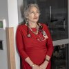 Dr. Banu Symington stands in a medical office with a stethoscope around her neck. 