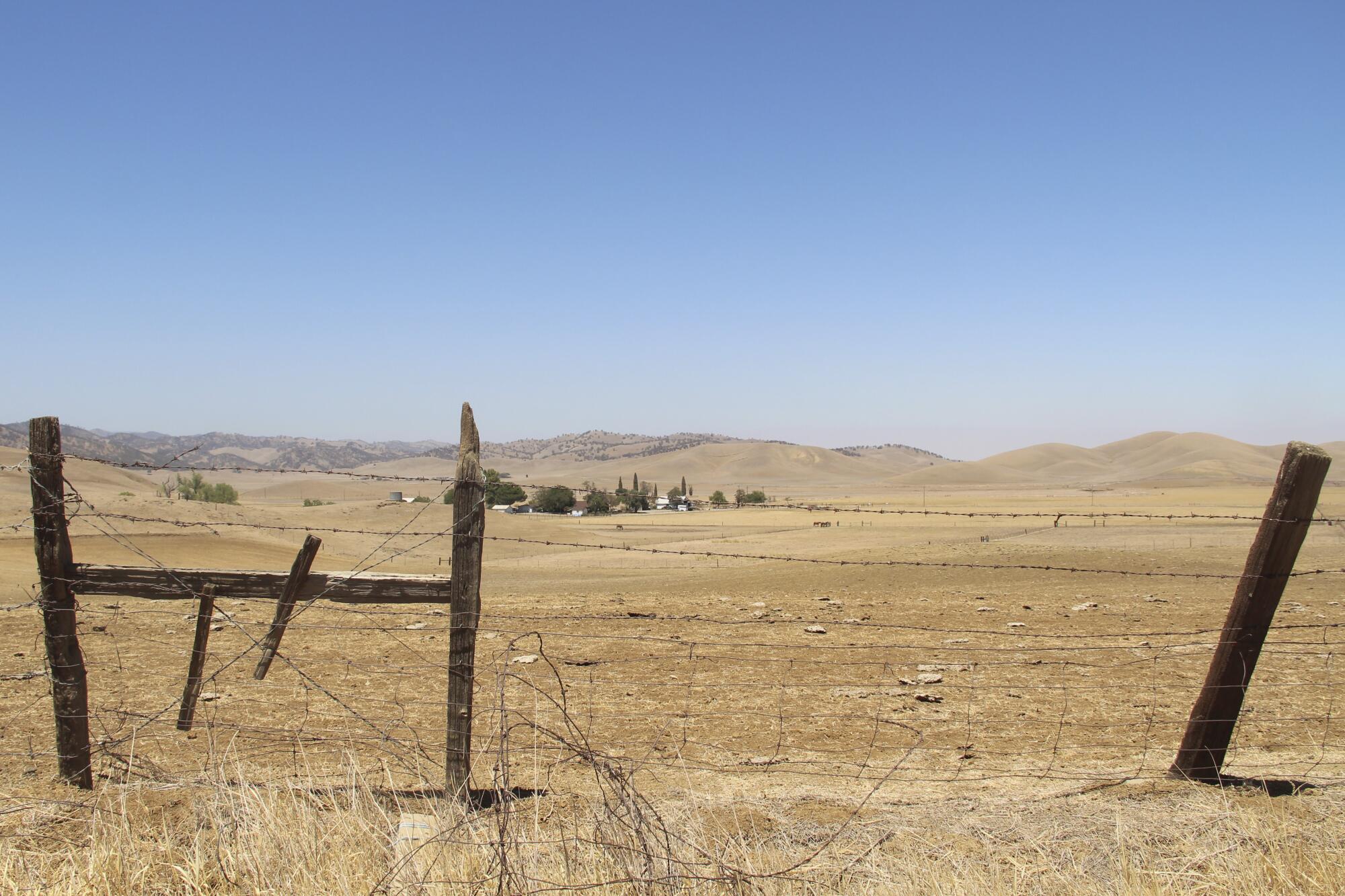 July 2021 photo of a barbed wire fence runs along a ranch in Sites. 