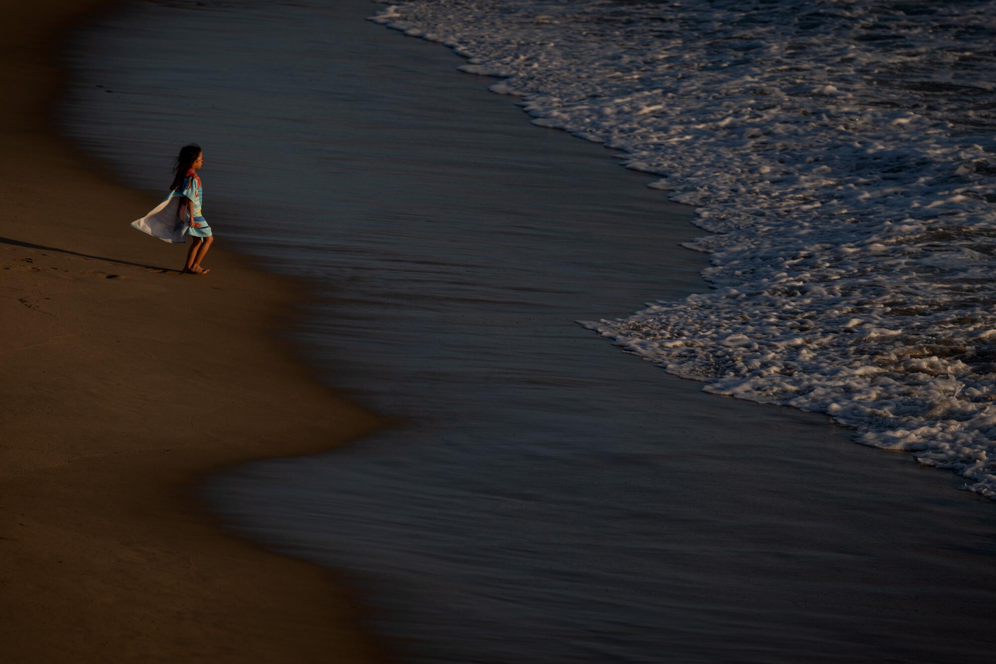 A girl plays in the water near the Hermosa Beach Pier, where the water temperature was 63°F. 