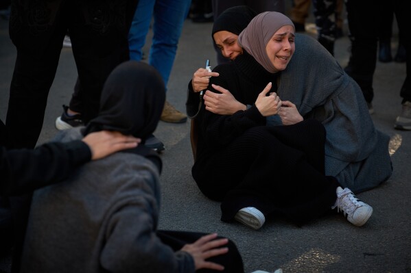 Mourners react during the funeral of 13 state security officers killed the previous day in an Israeli strike in Lebanon's coastal city of Sidon, Saturday, April 11, 2026. (AP Photo/Emilio Morenatti, File)