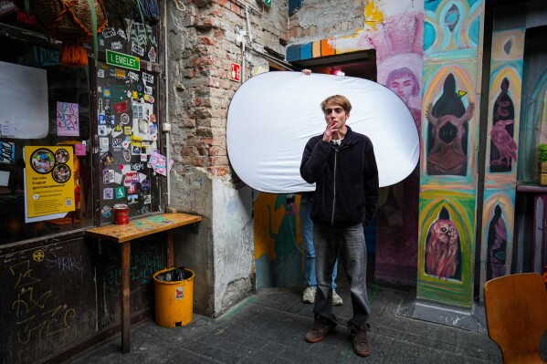 Gusztav Komaromy, 22, poses for a portrait as he smokes a cigarette in Budapest, Hungary, Monday, April 13, 2026. "We had a regime that took control of our lives and political consciousness. We had to take a stance about propaganda, about political cynicism, about the state of the public sphere. " (AP Photo/Petr David Josek, File)