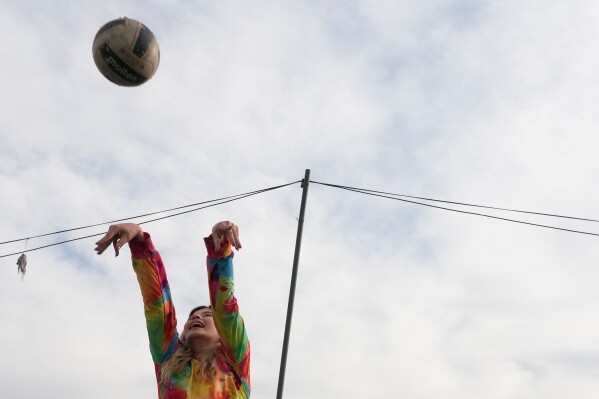 A woman plays volleyball at Pardisan Park in Tehran, Iran, Friday, April 10, 2026. (AP Photo/Vahid Salemi, File)