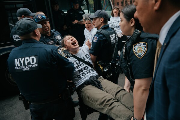 Protesters with Jewish Voice for Peace get arrested after blocking traffic during a demonstration outside the New York office of U.S. Sen. Chuck Schumer, calling for an end to the U.S.-Israel war with Iran and opposing U.S. weapons support on Monday, April 13, 2026, in New York. (AP Photo/Andres Kudacki, File)