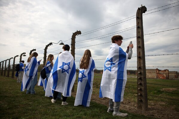 People take part in the annual "March of the Living" to commemorate the Holocaust, a yearly Holocaust remembrance march between the former death camps of Auschwitz and Birkenau, in Oswiecim, Poland, on Tuesday, April 14, 2026. (AP Photo/Beata Zawrzel, File)