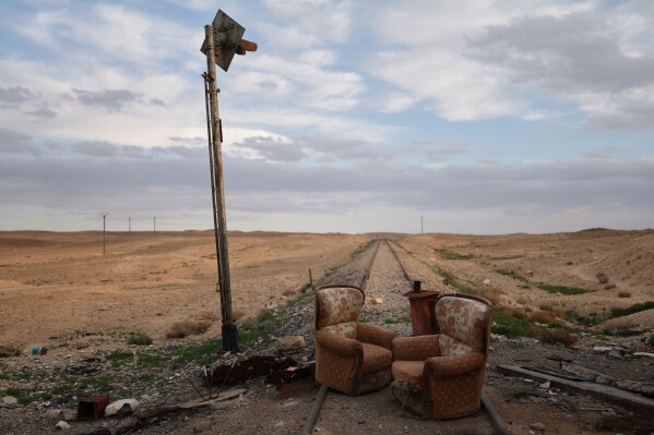 Two armchairs sit at an abandoned railway crossing used as a checkpoint by the Assad regime's Syrian army, east of Homs, Syria, Saturday, April 11, 2026. (AP Photo/Ghaith Alsayed, File)