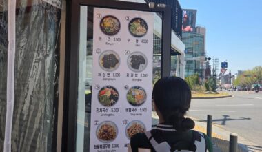 A university student examines a menu outside a restaurant in Seodaemun District, Seoul, April 7. Korea Times photo by Na Min-seo