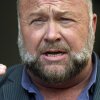 Right-wing conspiracy theorist Alex Jones speaks outside the federal courthouse after a June bankruptcy hearing in Houston.