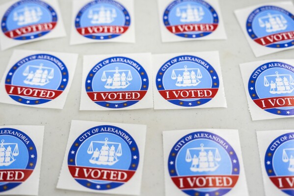 "I Voted" stickers are laid out on a table at Lyles-Crouch Traditional Academy on election day for the Virginia redistricting referendum, Tuesday, April 21, 2026, in Alexandria, Va. (AP Photo/Julia Demaree Nikhinson)