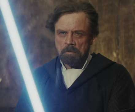 Luke holding his lightsaber in The Last Jedi