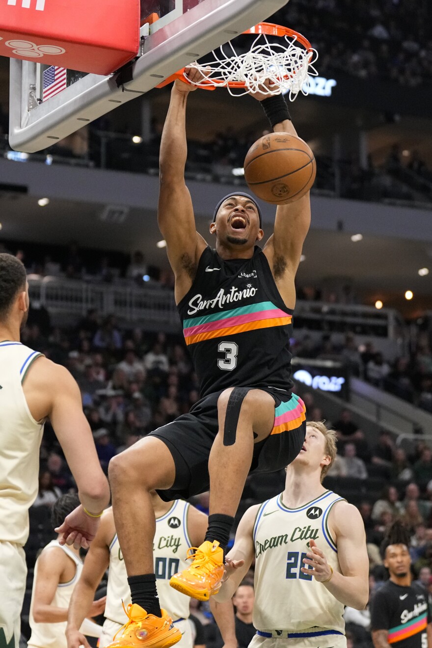 Mar 28, 2026; Milwaukee, Wisconsin, USA; San Antonio Spurs forward Keldon Johnson (3) dunks during the second quarter against the Milwaukee Bucks at Fiserv Forum.