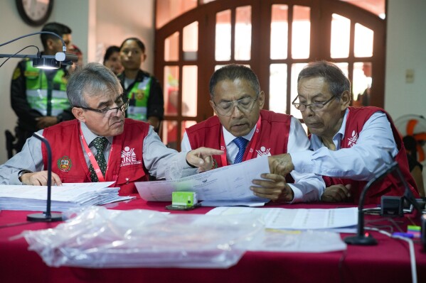 Special Electoral Jury appointees recount votes for the 2026 general election, in Lima, Peru, Wednesday, April 22, 2026. (AP Photo/Guadalupe Pardo, File)