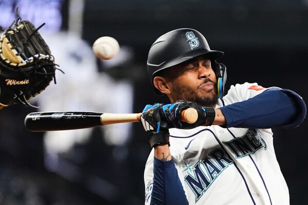 Seattle Mariners' Julio Rodríguez avoids a close pitch during an at-bat against the Athletics during the fifth inning of a baseball game, Wednesday, April 22, 2026, in Seattle. (AP Photo/Lindsey Wasson, File)