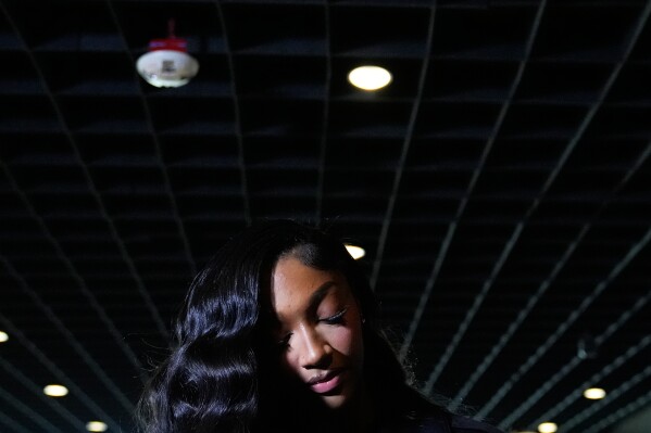 Men fish smelt fish (named locally as koryushka) known as a special local delicacy, famous for its "cucumber" smell, which passes in April from the Baltic Sea to Lake Ladoga via St. Petersburg to spawn, in St. Petersburg, Russia, Monday, April 20, 2026, with a highway bridge in the background. (AP Photo/Dmitri Lovetsky, File)
