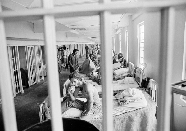 A prisoner lights a cigarette in the maximum security section of the Louisiana State prison at Angola, in December 1975. (AP Photo/Jack Thornell, File)