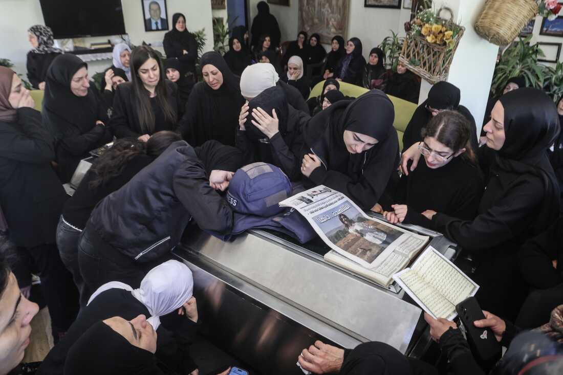 Relatives and friends of Amal Khalil, a veteran correspondent for the daily newspaper Al-Akhbar who was killed in a reported Israeli airstrike in southern Lebanon, mourn at her home in the village of Bisariyeh, on Thursday.