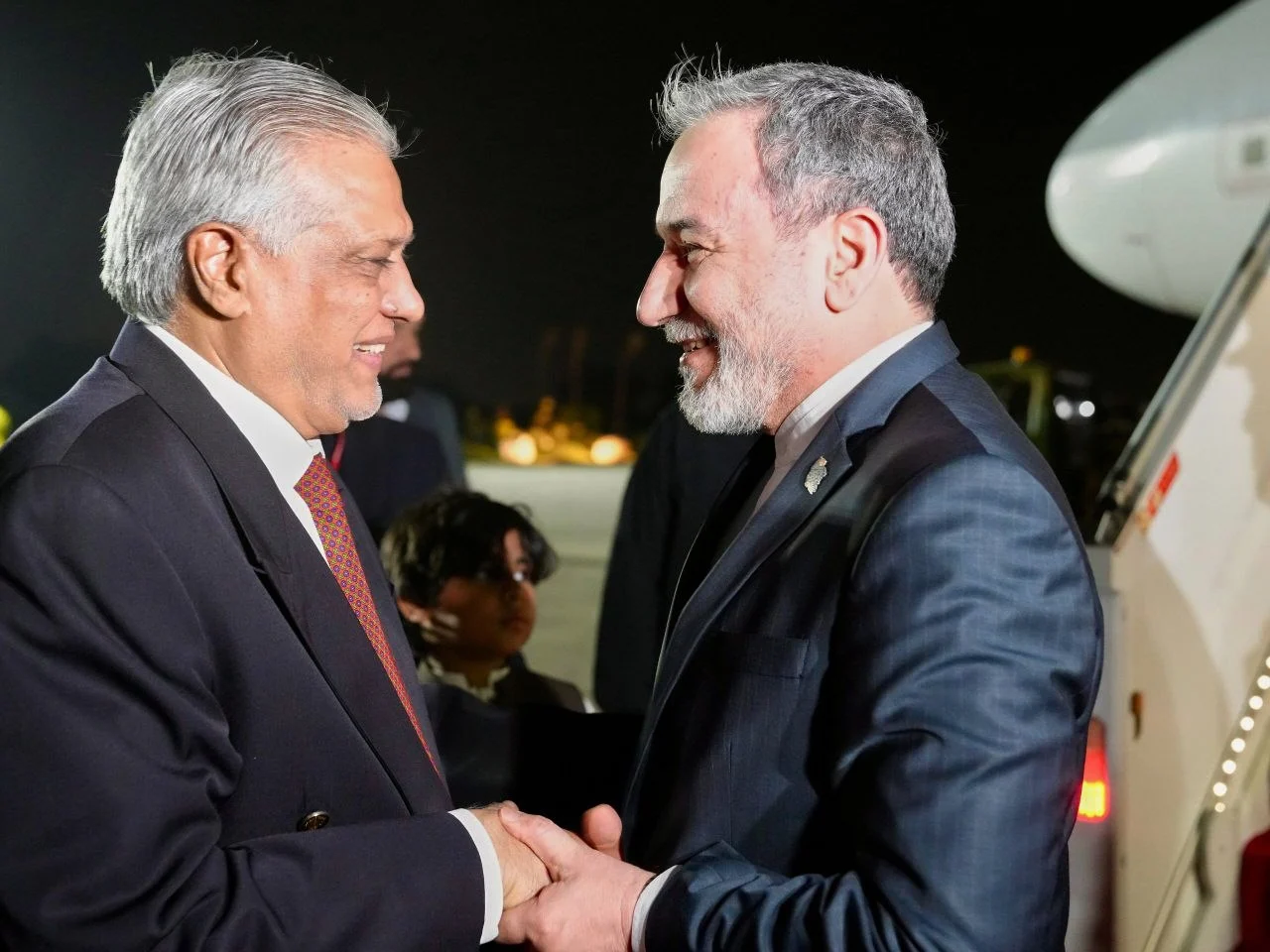 Iranian Foreign Minister Abbas Araghchi is welcomed by Pakistani Foreign Minister Ishaq Dar upon his arrival at Nur Khan airbase in Rawalpindi, Pakistan, on Friday.