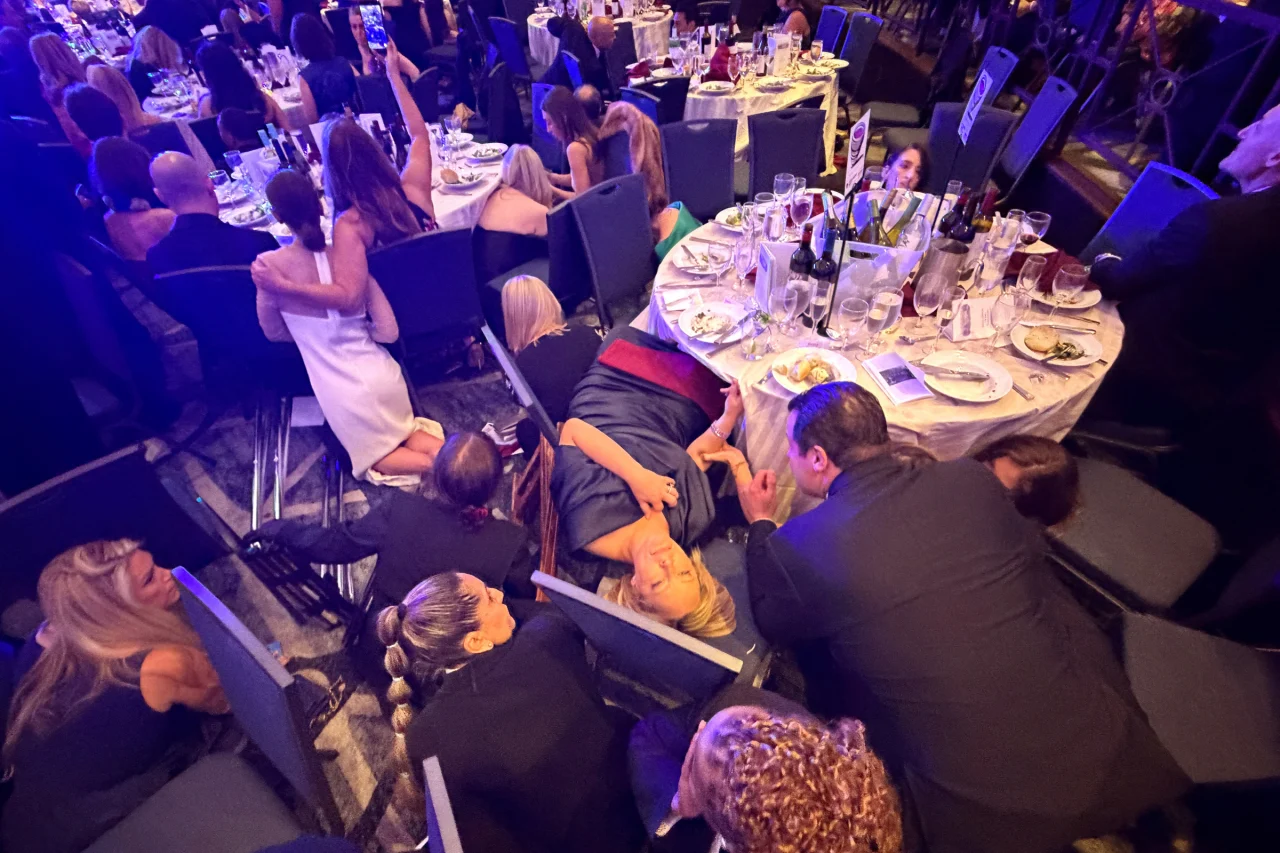 Guests take cover after US President Donald Trump and first lady Melania Trump were rushed out of the White House Correspondents' Association dinner.