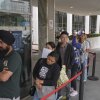 In June 2025, people stand in a long line outside the Los Angeles Federal Building.