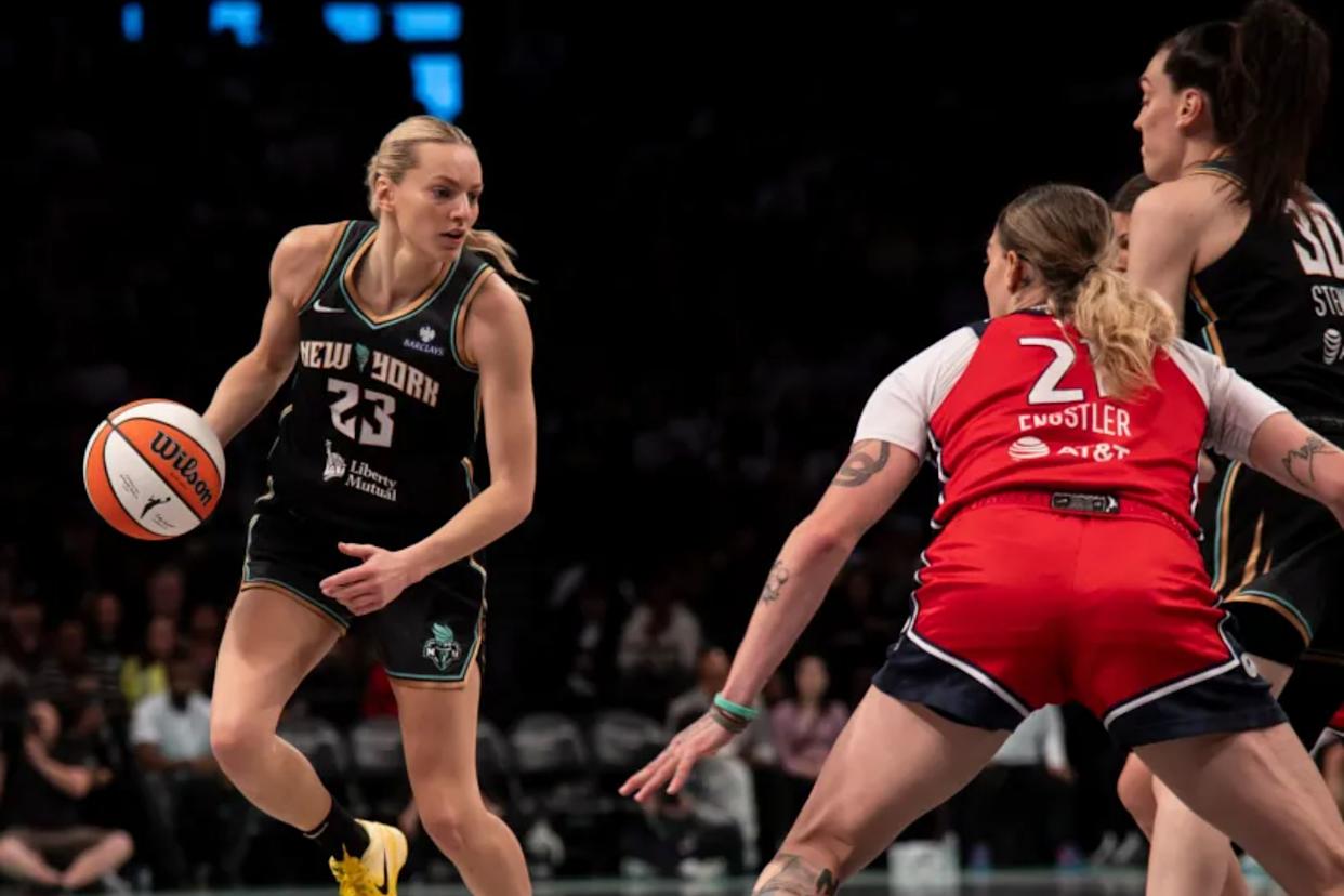 An image collage containing 1 images, Image 1 shows Marine Johannes dribbles the ball for the New York Liberty against Emily Engstler of the Washington Mystics