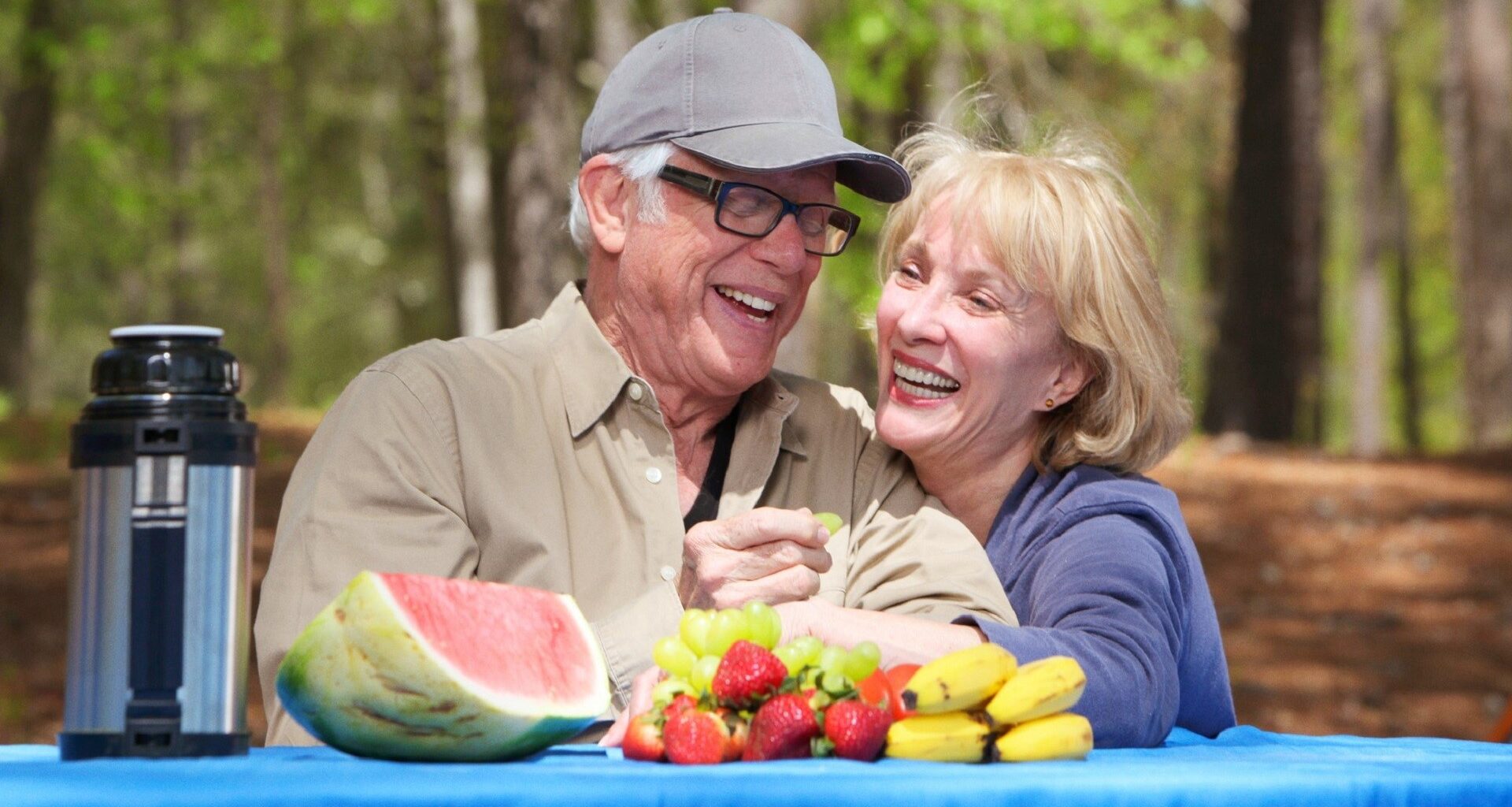 Smiling senior couple enjoying their time at a park for stock photo.