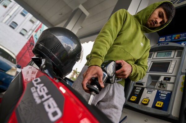 Neer Malik fills up just one gallon of gasoline to ride approximately 100 miles on his motorcycle at a gas station in Los Angeles on Friday, April 17, 2026. (AP Photo/Damian Dovarganes)