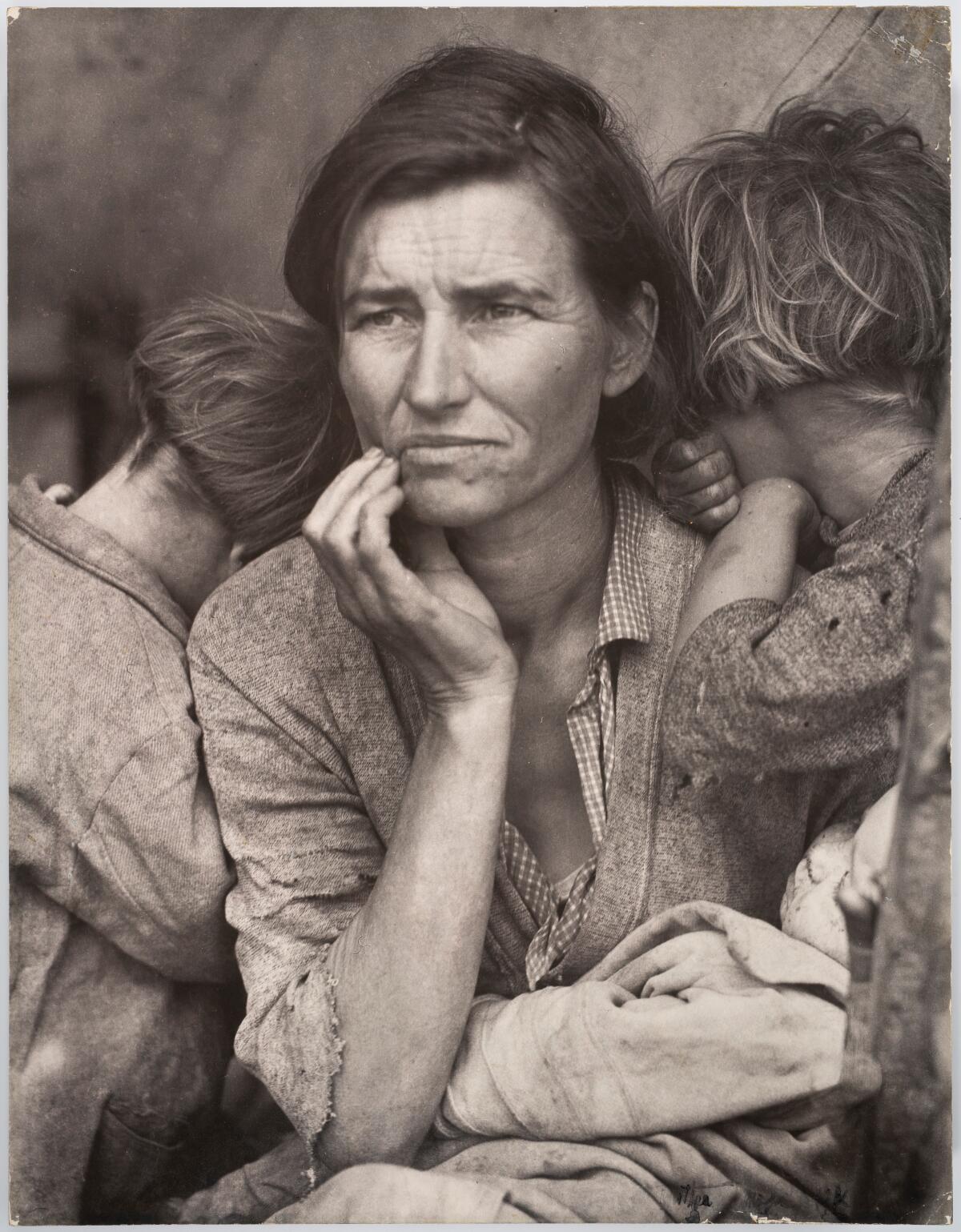 A mother flanked by her children. 