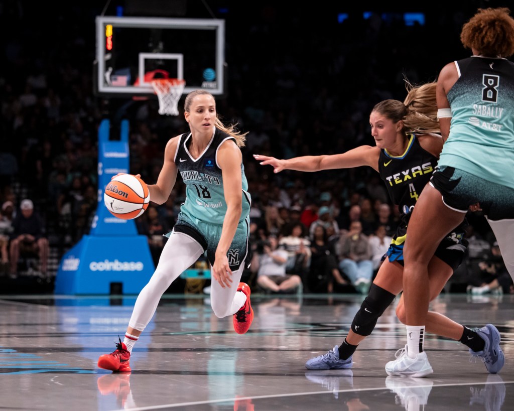 Ivana Dojkic of the New York Liberty drives the ball against Jacy Sheldon of the Dallas Wings.