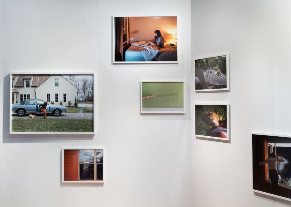 A booth with cinematic shoots of a woman performing in suburban environments.