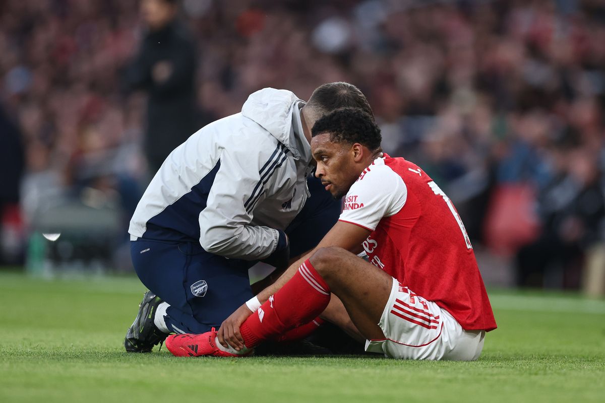 Jurrien Timber receives medical treatment during the Premier League match between Arsenal and Everton at Emirates Stadium.