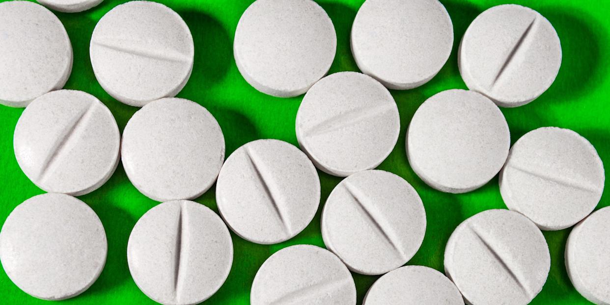 White tablets on a green background.