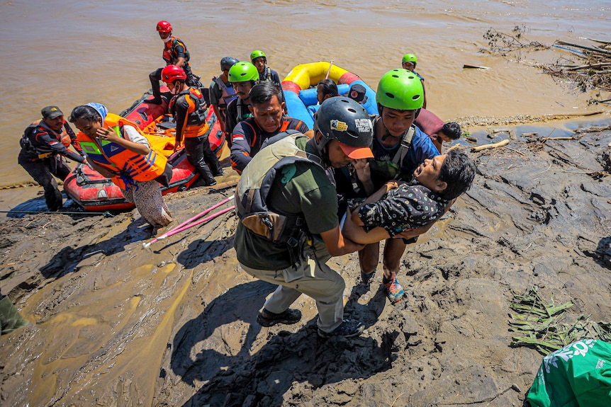 A man being rescued during Aceh floods in November 2025.