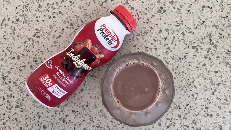 Indulgence Chocolate Covered Strawberry bottle with a glass cup