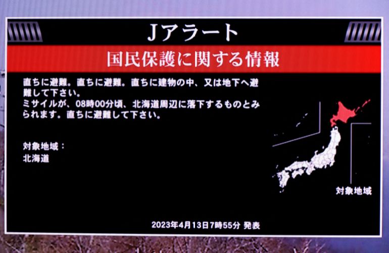 A TV screen displays a warning message called "J-alert" after the Japanese government issued an alert, following a ballistic missile launch by North Korea, in this photo taken in Tokyo, Japan April 13, 2023. The message reads: Japanese government warns citizens of the northernmost main island of Hokkaido to take immediate cover and stay inside buildings, saying a missile was likely to fall near the island. REUTERS/Issei Kato