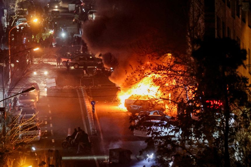 Cars burn in a street during a protest over the collapse of the currency's value, in Tehran, Iran on January 8.