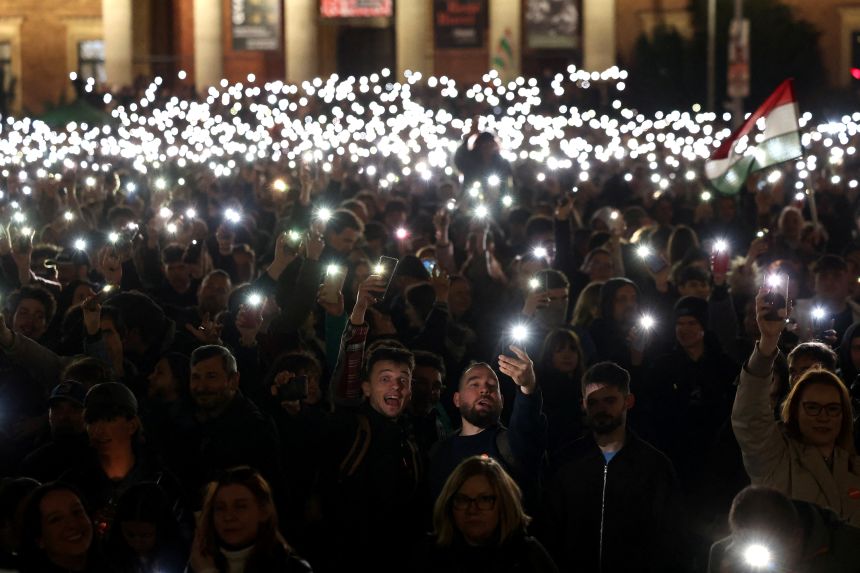 Hungarians shine their flashlights in a free concert to protest against Orbán's government in Budapest on Friday.